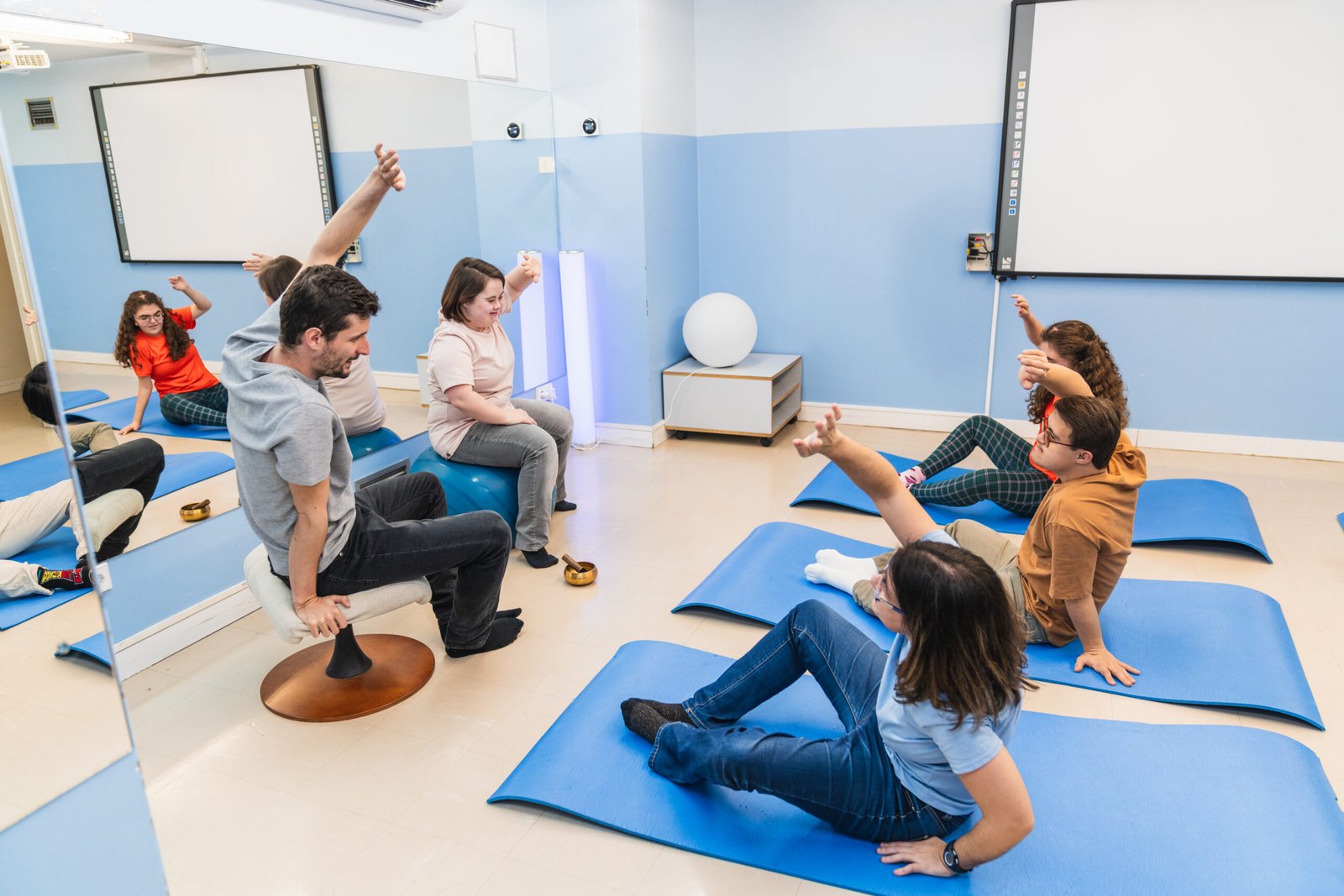 A lively yoga class with participants including those with Down syndrome.