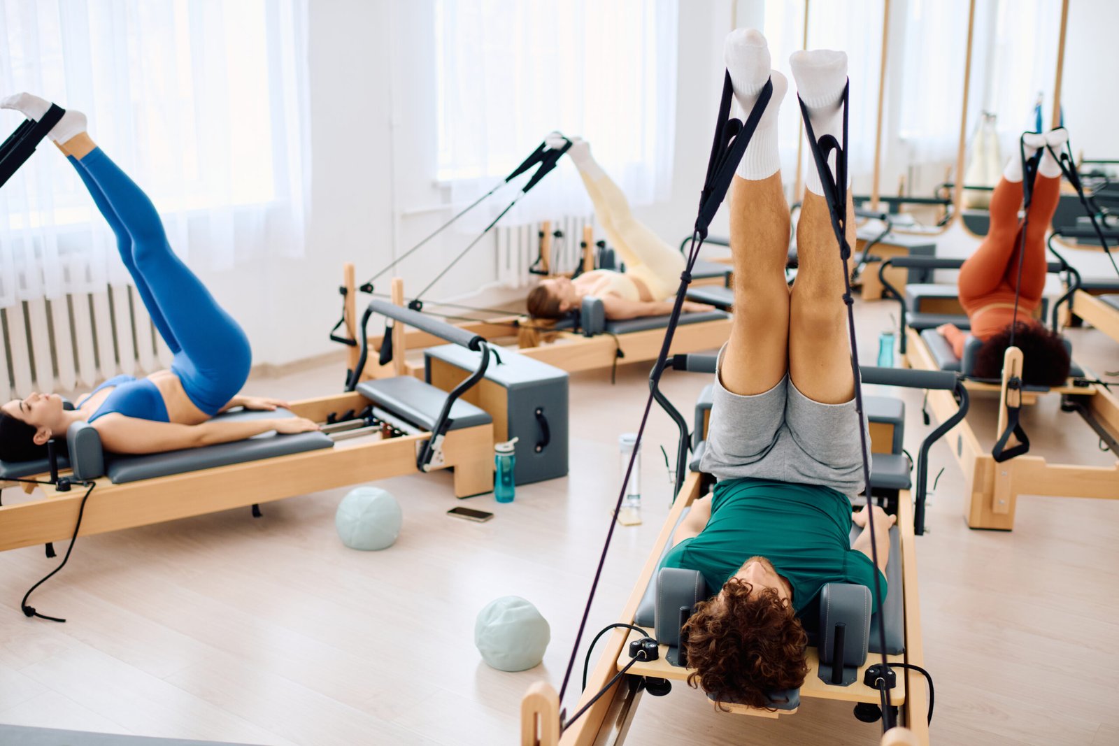 Participants engage in dynamic pilates, enhancing core strength and flexibility on reformers.